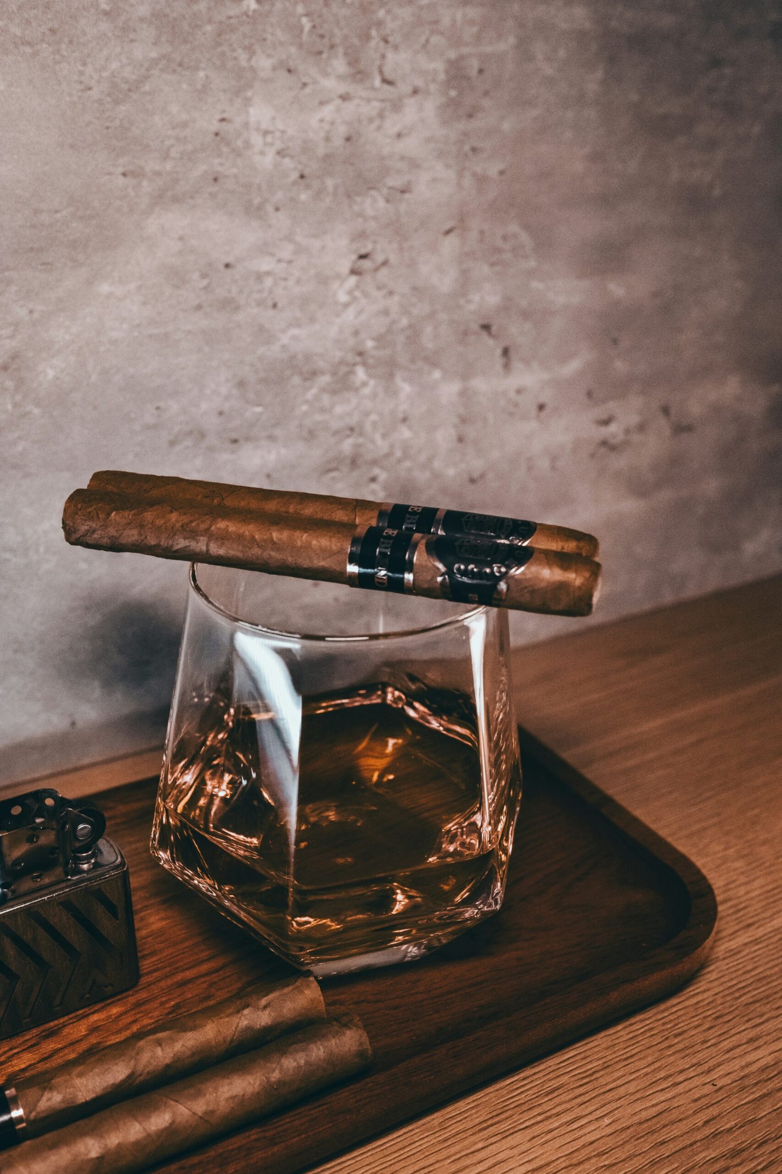 A cigar sitting on top of a wooden tray